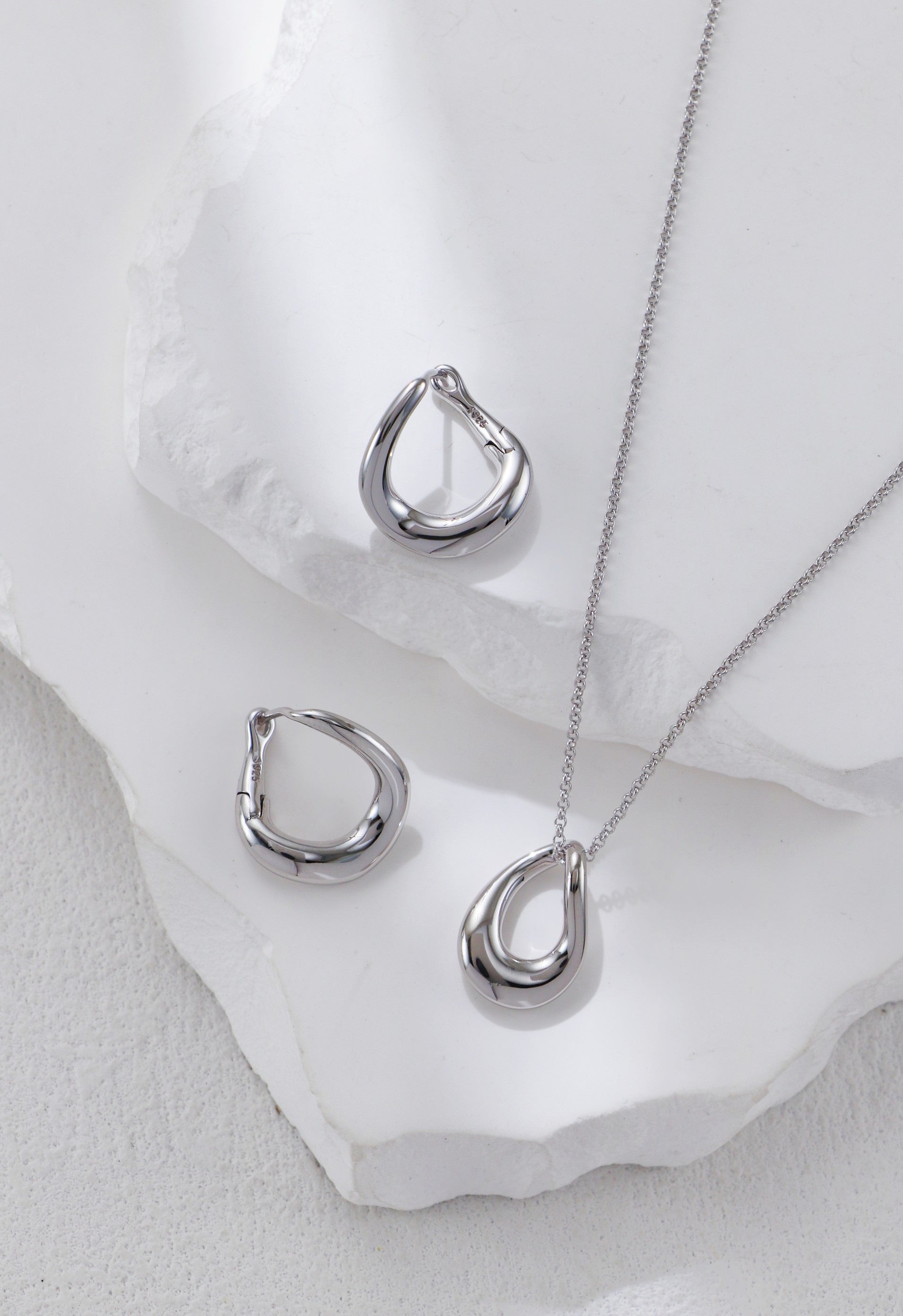 Sterling silver twisted necklace with matching stud earrings, a capsule wardrobe jewelry starter pairing