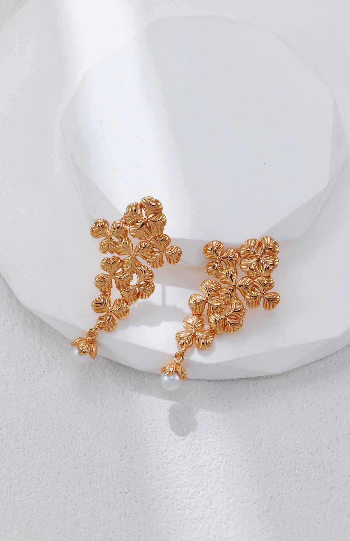Close-up of the vintage gold floral cluster earrings with freshwater pearl drop