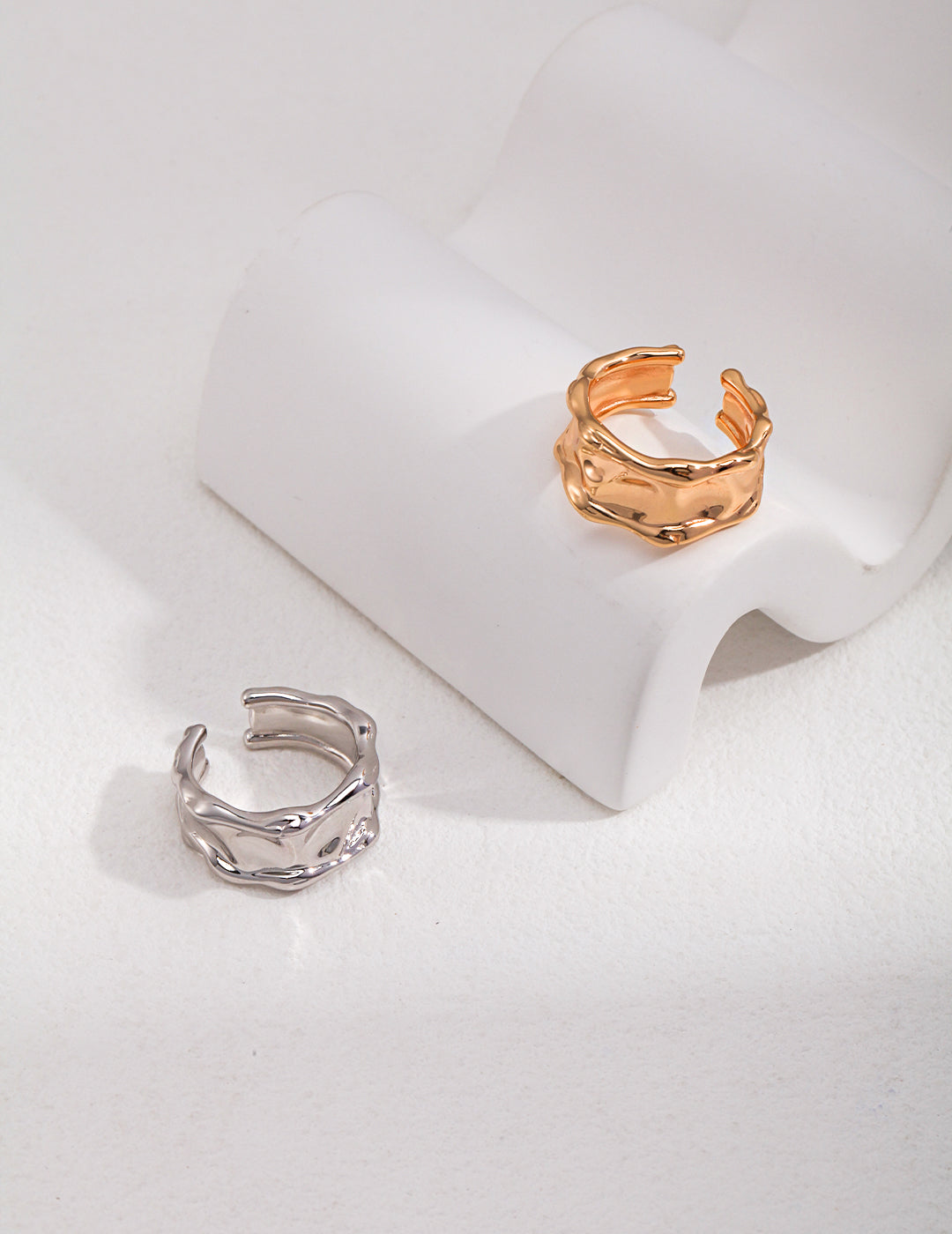 A solid S925 sterling silver wide band ring resting on a neutral surface, illustrating how to measure your ring size at home.