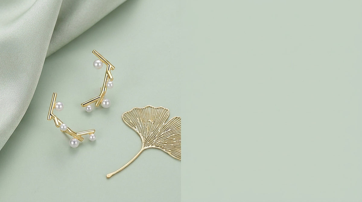 Sterling silver and pearl drop earrings on a celadon background