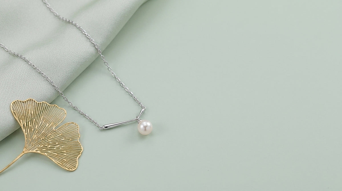 Sterling silver freshwater pearl pendant necklace on a celadon background