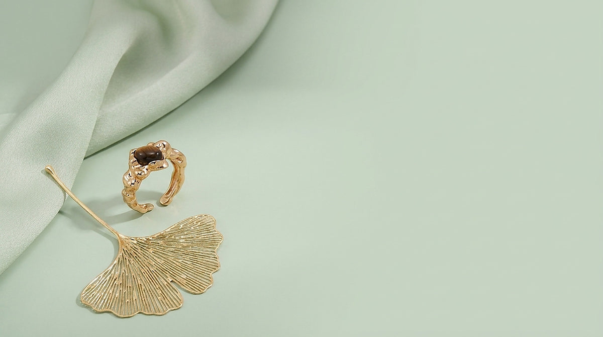 Sterling silver ornate stone ring on a celadon background
